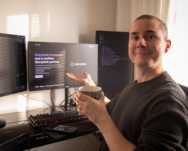 Jere Huttunen posing beside his computer with the Storyblok development page open on screen