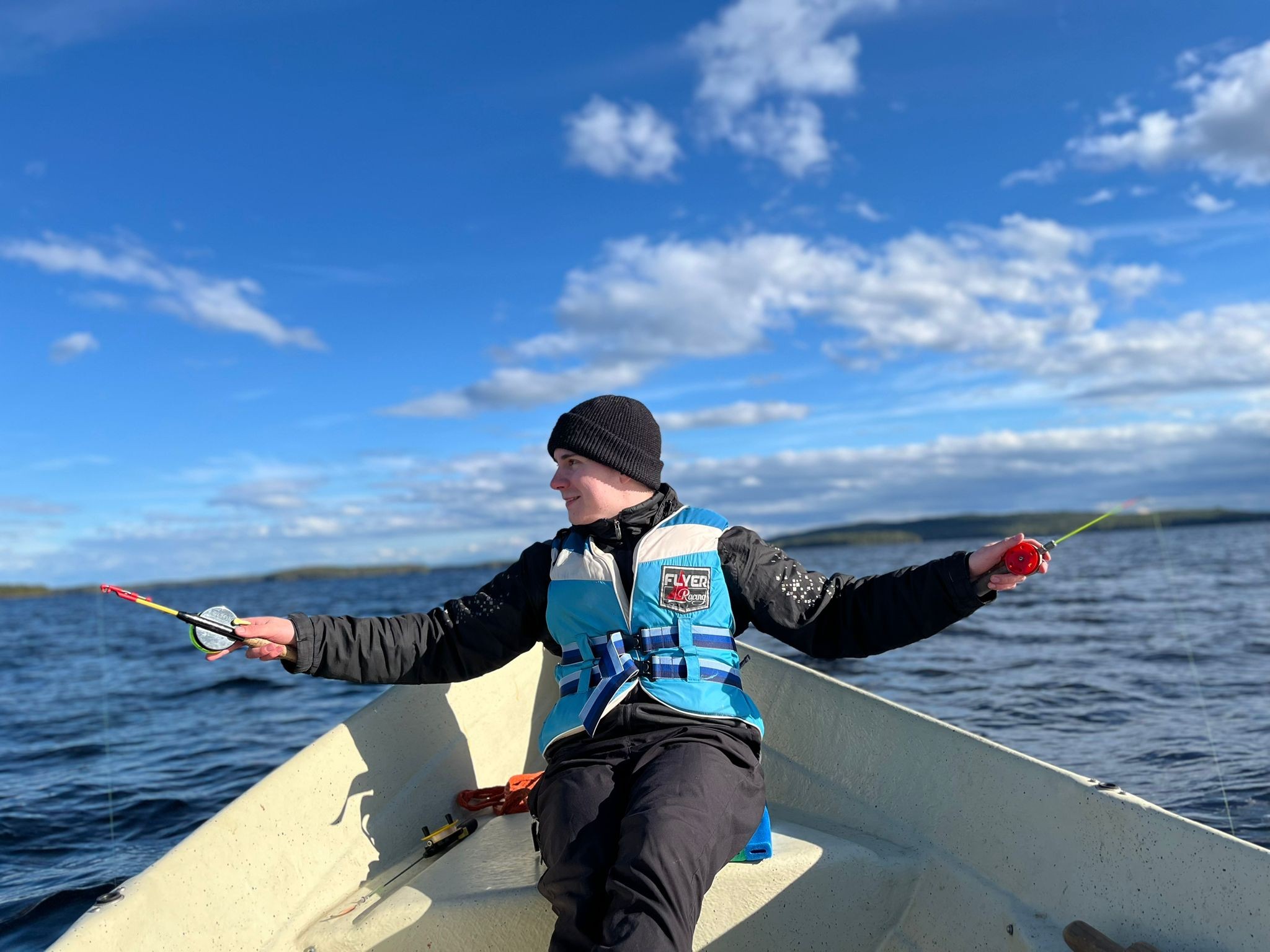Jere fishing from a boat on a lake